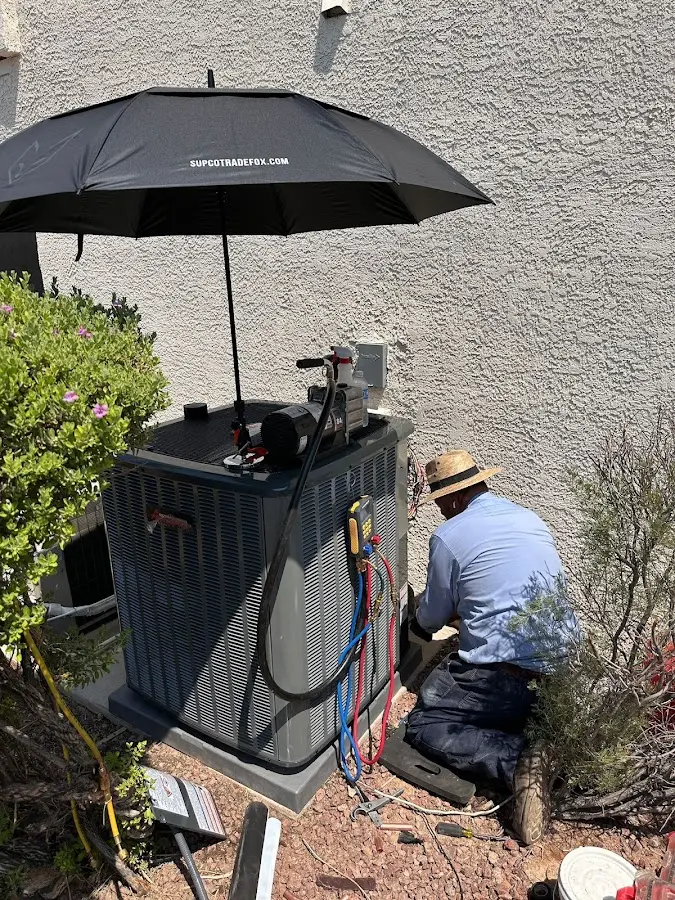 HVAC technician performing outdoor AC maintenance in Franklin